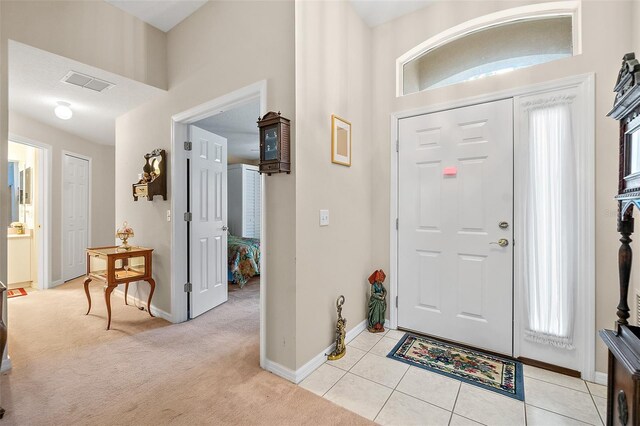 10 Chatham Pl Unit 10, Palm Coast, FL 32164 - foyer entrance featuring baseboards, light colored carpet, light tile patterned floors, and healthy amount of natural light