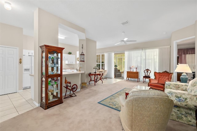 10 Chatham Pl Unit 10, Palm Coast, FL 32164 - living room featuring light colored carpet, ceiling fan, baseboards, and light tile patterned floors