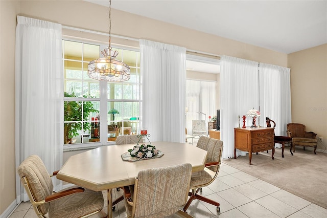 10 Chatham Pl Unit 10, Palm Coast, FL 32164 - dining room featuring light carpet, a chandelier, and light tile patterned floors