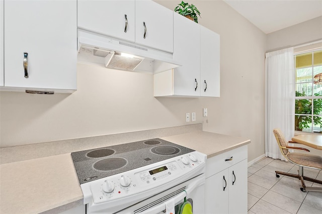 10 Chatham Pl Unit 10, Palm Coast, FL 32164 - kitchen featuring electric stove, under cabinet range hood, light countertops, and white cabinets