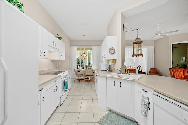 10 Chatham Pl Unit 10, Palm Coast, FL 32164 - kitchen with white appliances, a sink, light countertops, decorative light fixtures, and light tile patterned floors