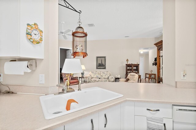 10 Chatham Pl Unit 10, Palm Coast, FL 32164 - kitchen featuring a sink, light countertops, open floor plan, white cabinets, and dishwasher
