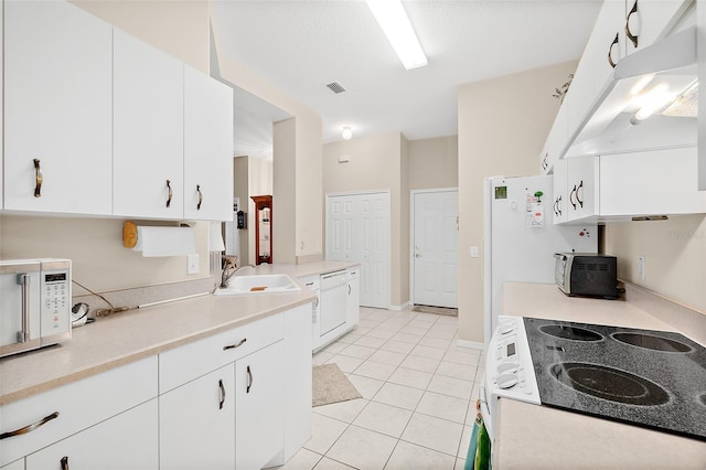 10 Chatham Pl Unit 10, Palm Coast, FL 32164 - kitchen with range, white microwave, under cabinet range hood, a sink, and light countertops