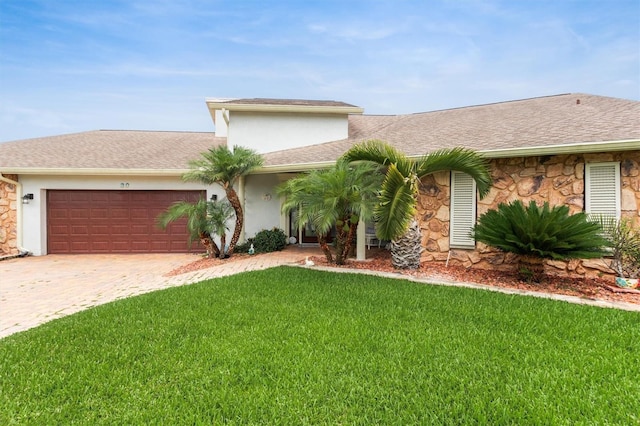 30 Clermont Ct, Palm Coast, FL 32137 - view of front of house featuring stone siding, an attached garage, a front lawn, decorative driveway, and stucco siding