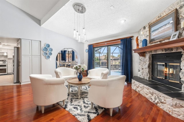 30 Clermont Ct, Palm Coast, FL 32137 - living room with a textured ceiling, wood finished floors, and a stone fireplace