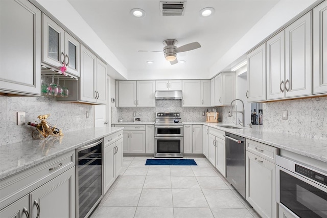 30 Clermont Ct, Palm Coast, FL 32137 - kitchen featuring beverage cooler, appliances with stainless steel finishes, under cabinet range hood, a sink, and light tile patterned flooring