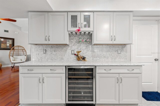 30 Clermont Ct, Palm Coast, FL 32137 - indoor dry bar with beverage cooler, tasteful backsplash, ceiling fan, and wood finished floors