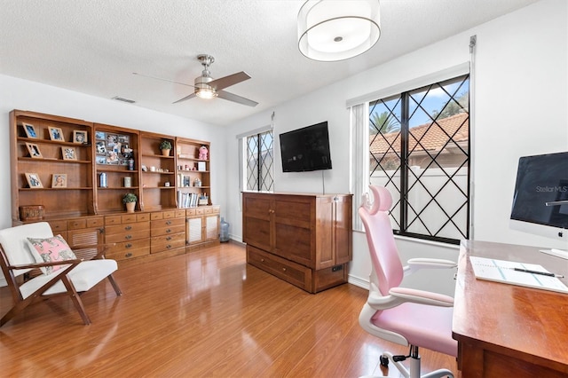 30 Clermont Ct, Palm Coast, FL 32137 - office space featuring light wood-type flooring, a ceiling fan, a textured ceiling, and baseboards