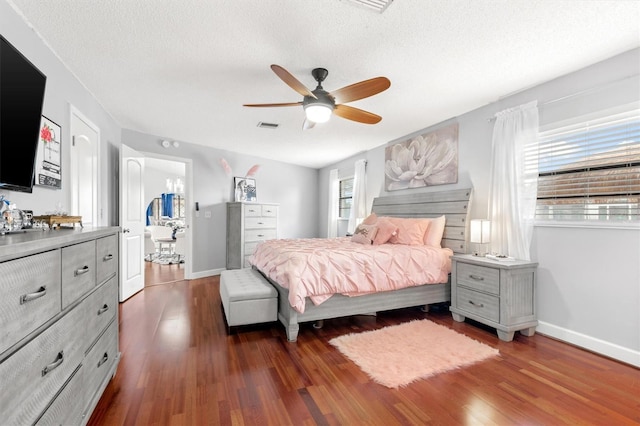 30 Clermont Ct, Palm Coast, FL 32137 - bedroom with dark wood-style floors, baseboards, a textured ceiling, and ceiling fan