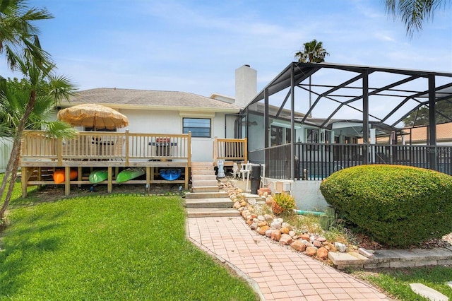 30 Clermont Ct, Palm Coast, FL 32137 - back of house with a lawn, a chimney, stucco siding, a wooden deck, and a lanai