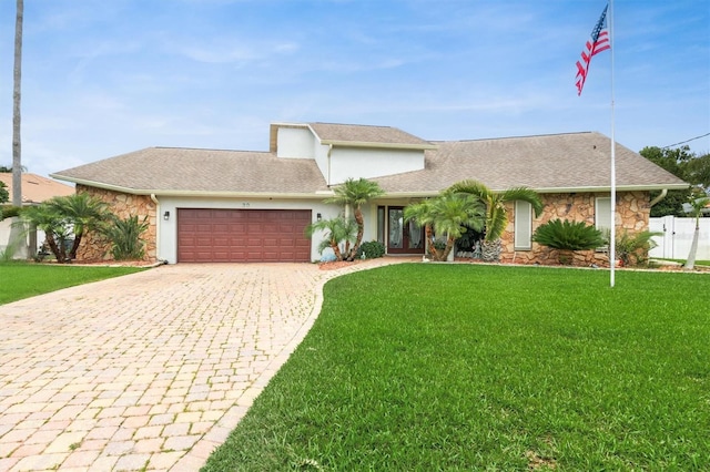 30 Clermont Ct, Palm Coast, FL 32137 - mid-century inspired home with stone siding, an attached garage, decorative driveway, french doors, and stucco siding