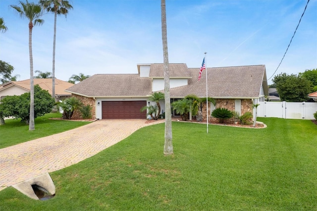 30 Clermont Ct, Palm Coast, FL 32137 - mid-century inspired home featuring an attached garage, decorative driveway, a gate, and a shingled roof
