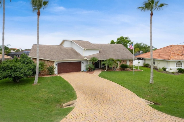 30 Clermont Ct, Palm Coast, FL 32137 - view of front of property with a garage, decorative driveway, a front yard, and roof with shingles