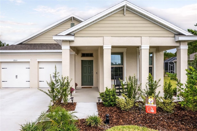 2861 Monaghan Dr, Ormond Beach, FL 32174 - view of front of home featuring concrete driveway, an attached garage, covered porch, a shingled roof, and stucco siding