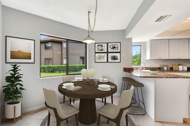 13 Hembury Ln, Palm Coast, FL 32137 - dining area with baseboards and light tile patterned floors