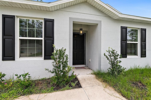 24 Beacon Mill Ln, Palm Coast, FL 32137 - view of exterior entry featuring stucco siding