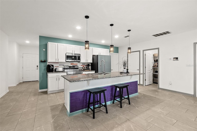 24 Beacon Mill Ln, Palm Coast, FL 32137 - kitchen with stainless steel appliances, an island with sink, recessed lighting, a kitchen breakfast bar, and a sink