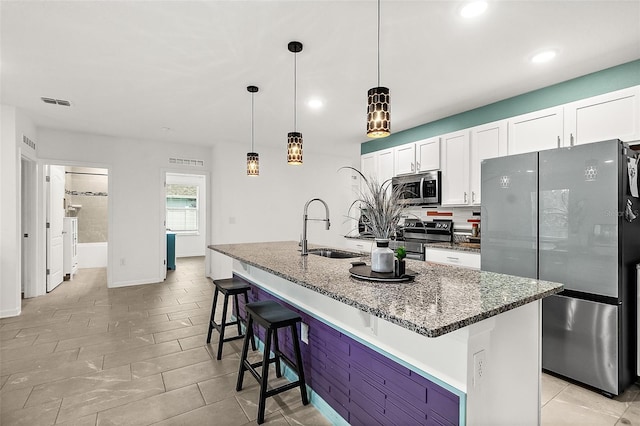 24 Beacon Mill Ln, Palm Coast, FL 32137 - kitchen with appliances with stainless steel finishes, a sink, recessed lighting, dark stone countertops, and white cabinets