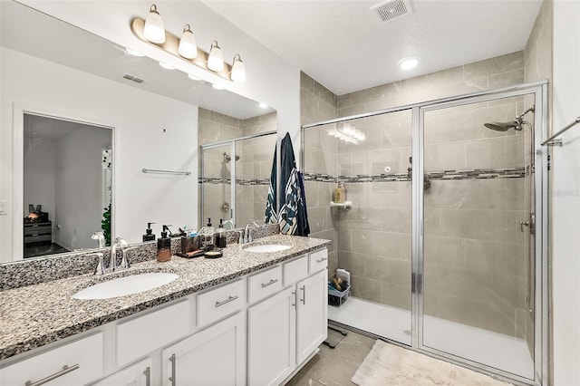 24 Beacon Mill Ln, Palm Coast, FL 32137 - full bath featuring double vanity, a stall shower, and tile patterned flooring