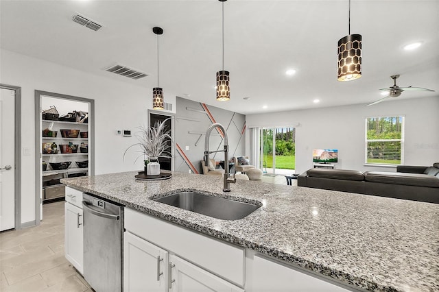 24 Beacon Mill Ln, Palm Coast, FL 32137 - kitchen with stainless steel dishwasher, a sink, open floor plan, ceiling fan, and white cabinets