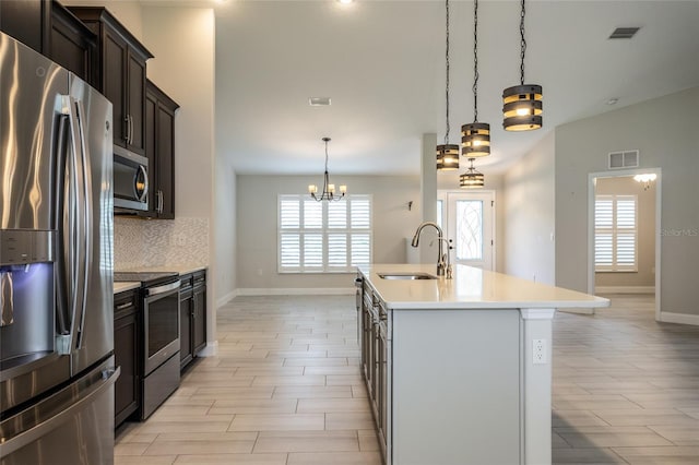 127 Wynnfield Dr, Palm Coast, FL 32164 - kitchen featuring appliances with stainless steel finishes, a sink, plenty of natural light, and tasteful backsplash