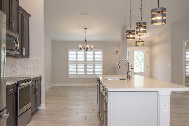127 Wynnfield Dr, Palm Coast, FL 32164 - kitchen with stainless steel appliances, a sink, light countertops, decorative backsplash, and baseboards