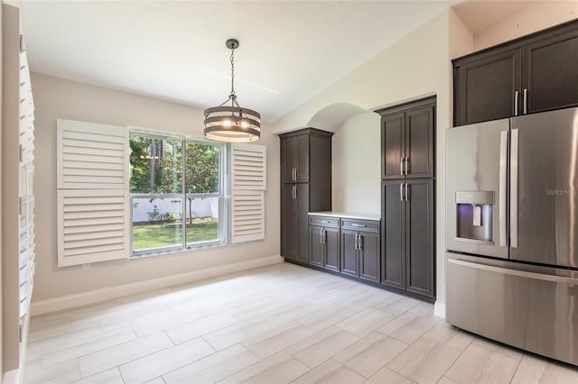 127 Wynnfield Dr, Palm Coast, FL 32164 - kitchen featuring stainless steel refrigerator with ice dispenser, dark brown cabinets, baseboards, light countertops, and decorative light fixtures