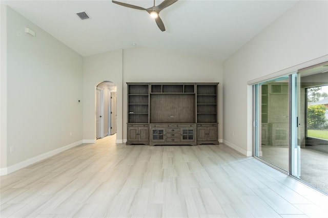 127 Wynnfield Dr, Palm Coast, FL 32164 - unfurnished living room with arched walkways, ceiling fan, lofted ceiling, baseboards, and light wood-type flooring