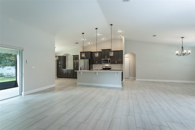 127 Wynnfield Dr, Palm Coast, FL 32164 - kitchen featuring stainless steel appliances, open floor plan, arched walkways, light countertops, and a chandelier