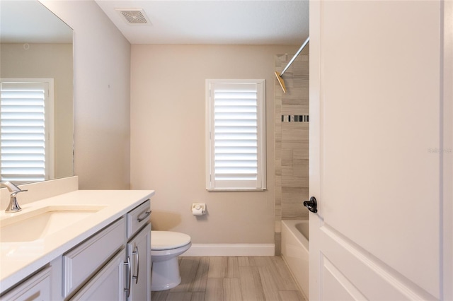 127 Wynnfield Dr, Palm Coast, FL 32164 - bathroom featuring vanity, toilet, baseboards, and shower / bathtub combination