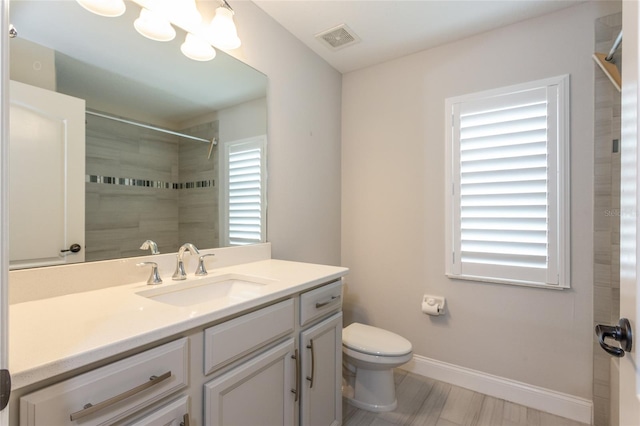 127 Wynnfield Dr, Palm Coast, FL 32164 - full bath with vanity, toilet, a tile shower, and baseboards