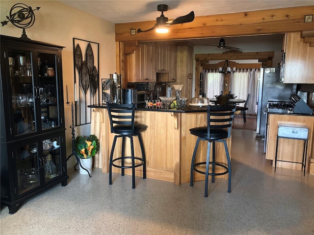 33 Camellia Dr, Ormond Beach, FL 32176 - kitchen with a ceiling fan, dark aggregate flooring, dark countertops, a breakfast bar, and a peninsula