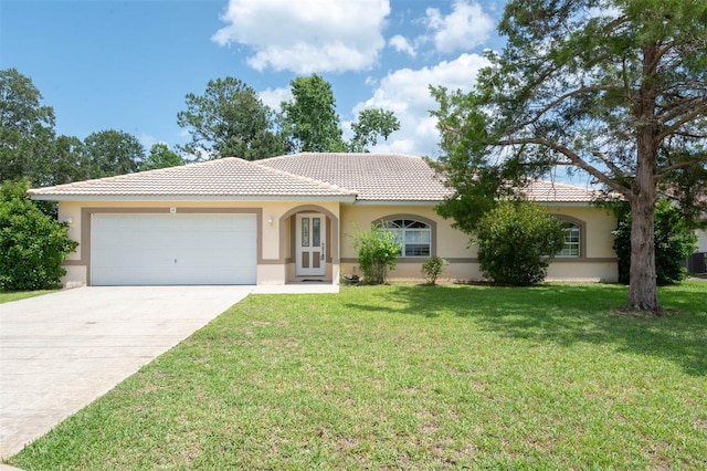 88 Pritchard Dr, Palm Coast, FL 32164 - mediterranean / spanish home with a tiled roof, stucco siding, an attached garage, a front yard, and concrete driveway