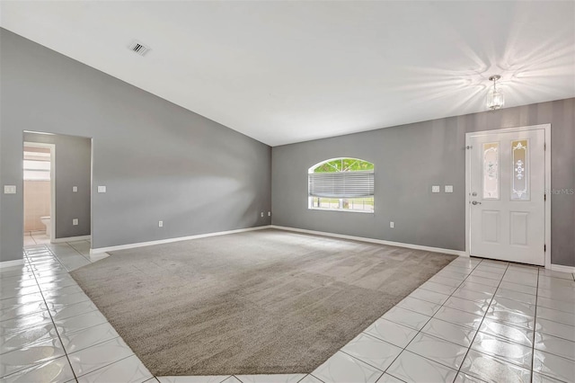 88 Pritchard Dr, Palm Coast, FL 32164 - entrance foyer with vaulted ceiling, light tile patterned flooring, and light carpet