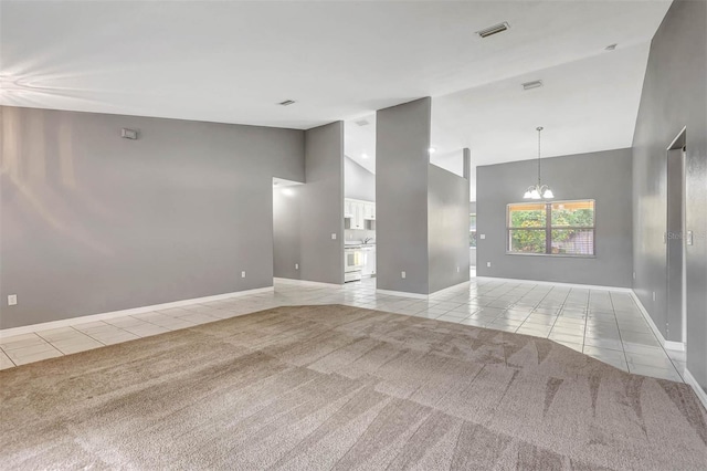 88 Pritchard Dr, Palm Coast, FL 32164 - unfurnished living room featuring light tile patterned floors, high vaulted ceiling, light colored carpet, and a chandelier