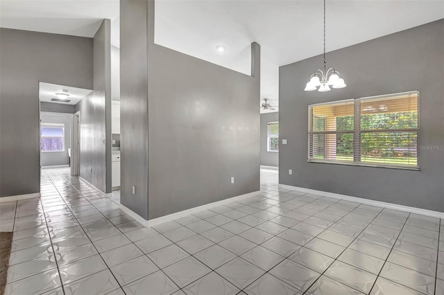 88 Pritchard Dr, Palm Coast, FL 32164 - spare room featuring high vaulted ceiling, light tile patterned floors, and a chandelier