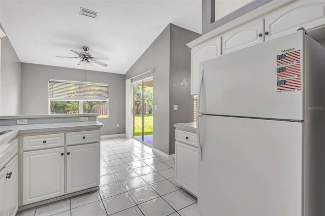 88 Pritchard Dr, Palm Coast, FL 32164 - kitchen with freestanding refrigerator, light countertops, ceiling fan, vaulted ceiling, and white cabinetry