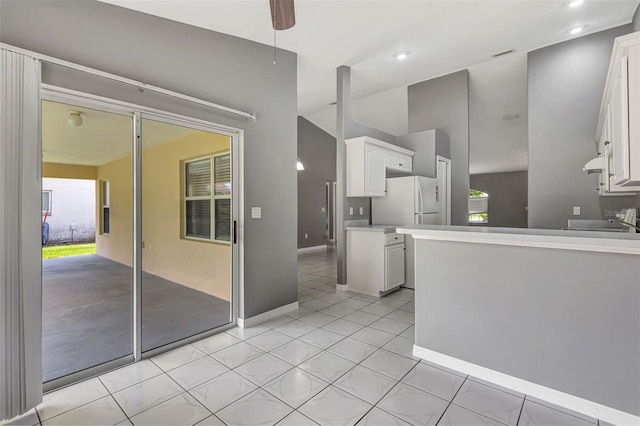 88 Pritchard Dr, Palm Coast, FL 32164 - kitchen with freestanding refrigerator, white cabinetry, under cabinet range hood, light countertops, and recessed lighting