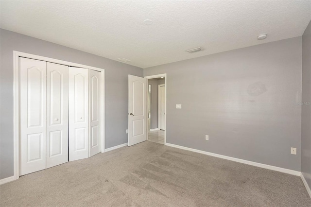88 Pritchard Dr, Palm Coast, FL 32164 - unfurnished bedroom featuring light carpet, a closet, and a textured ceiling