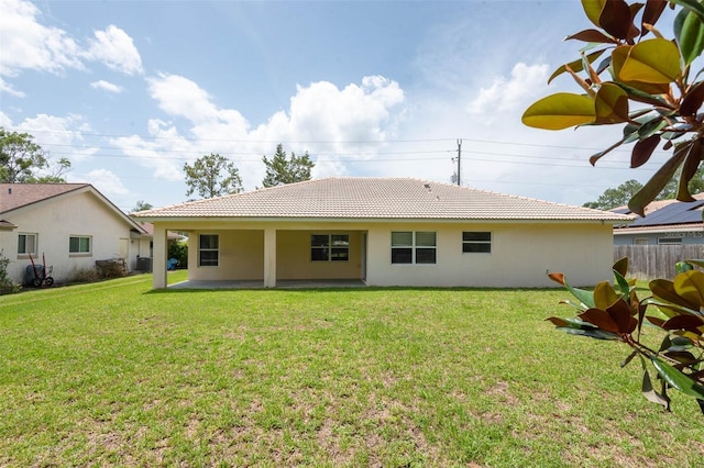 88 Pritchard Dr, Palm Coast, FL 32164 - back of house with stucco siding, a tiled roof, and a patio area