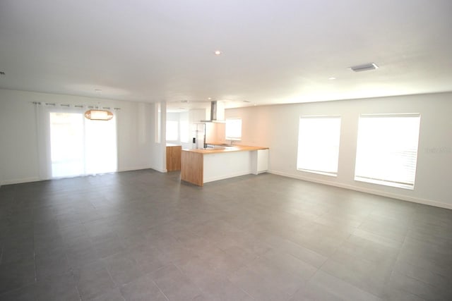 19 Cedarfield Ct, Palm Coast, FL 32137 - unfurnished living room featuring baseboards and recessed lighting
