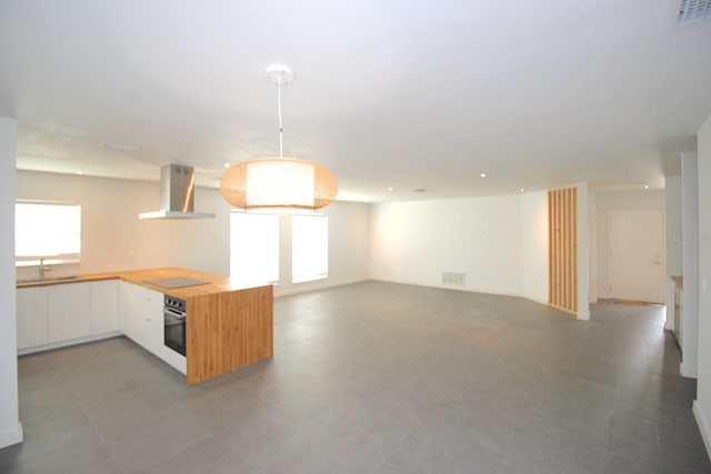 19 Cedarfield Ct, Palm Coast, FL 32137 - kitchen featuring wall chimney range hood, stainless steel oven, plenty of natural light, black electric stovetop, and recessed lighting