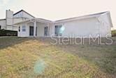 19 Cedarfield Ct, Palm Coast, FL 32137 - view of front of property with a front yard and a chimney