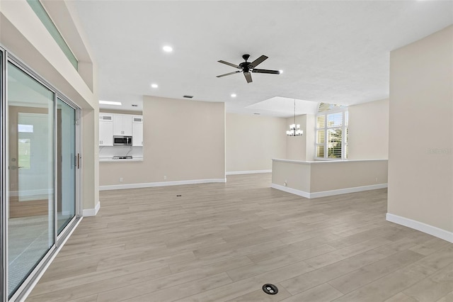 38 Kingsley Cir, Ormond Beach, FL 32174 - unfurnished living room with a chandelier, light wood-style floors, baseboards, a ceiling fan, and recessed lighting