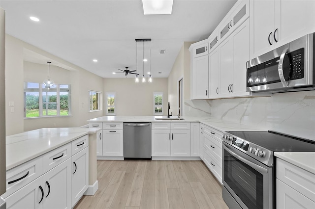38 Kingsley Cir, Ormond Beach, FL 32174 - kitchen with stainless steel appliances, a sink, healthy amount of natural light, light wood-style floors, and recessed lighting