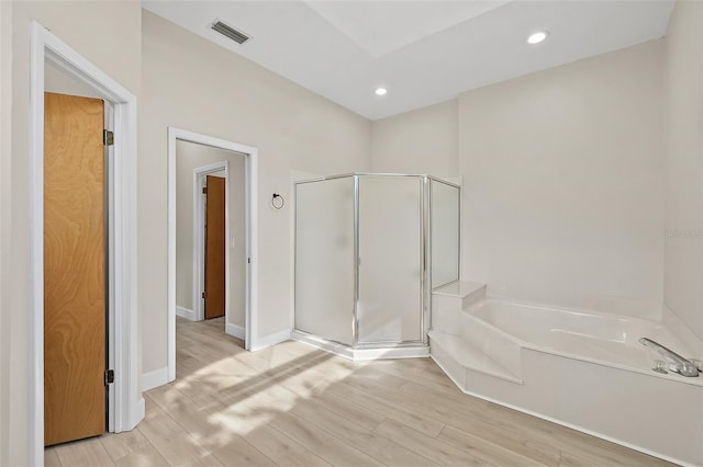 38 Kingsley Cir, Ormond Beach, FL 32174 - full bath featuring a stall shower, a bath, wood finished floors, recessed lighting, and baseboards