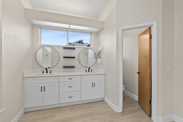 38 Kingsley Cir, Ormond Beach, FL 32174 - full bathroom with double vanity, toilet, wood finished floors, and baseboards