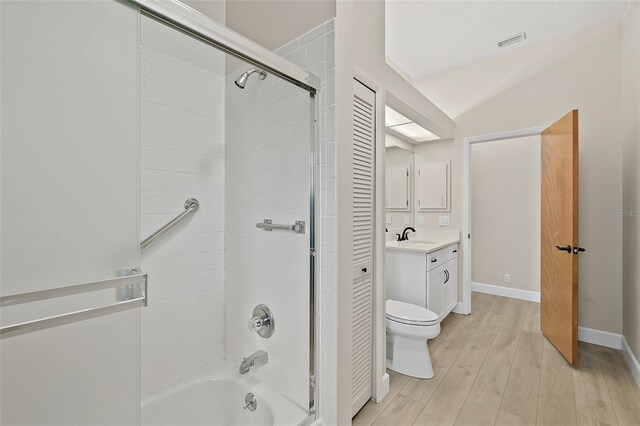38 Kingsley Cir, Ormond Beach, FL 32174 - full bathroom featuring vanity, wood finished floors, enclosed tub / shower combo, toilet, and baseboards