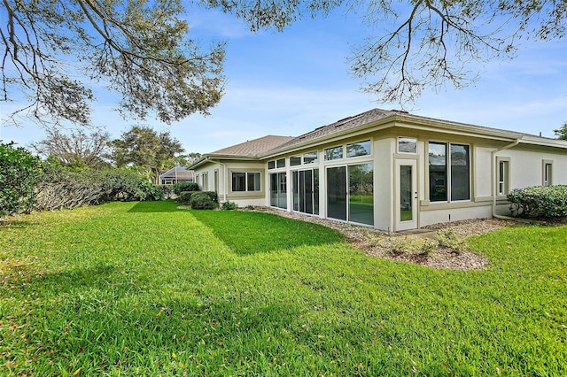 38 Kingsley Cir, Ormond Beach, FL 32174 - rear view of property with stucco siding, a sunroom, and a lawn