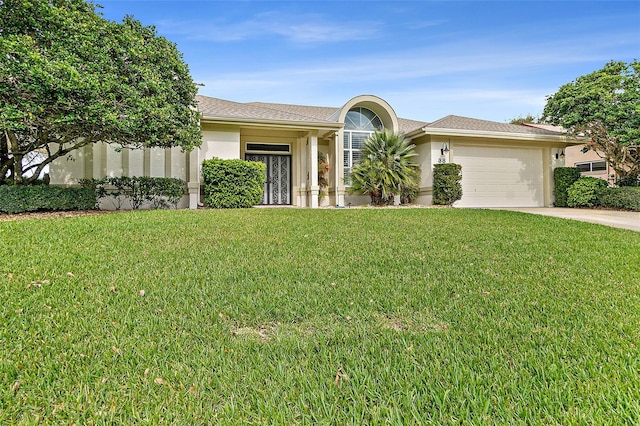 38 Kingsley Cir, Ormond Beach, FL 32174 - ranch-style house featuring a garage, concrete driveway, a front yard, and stucco siding